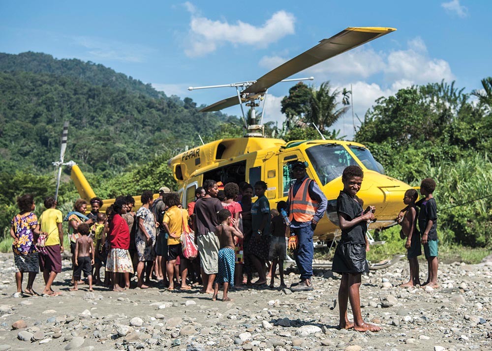 Defense POW/MIA Accounting Agency helicopter with group of people